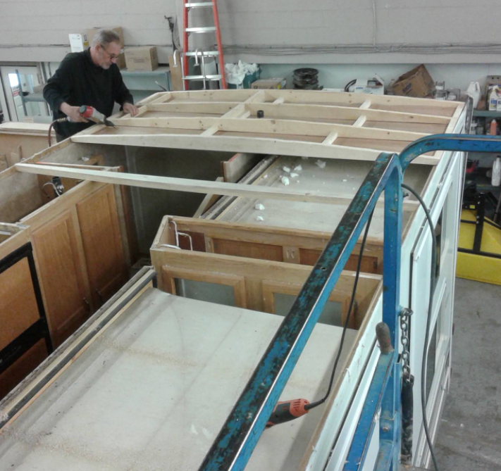 Service technician building a complete new RV roof